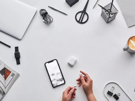 top view photo of person holding earphones